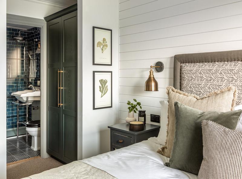 A calming bedroom decorated in whites and greens
