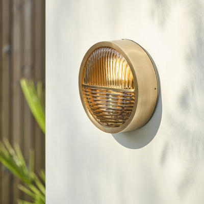 Bulkhead Outdoor & Bathroom Round Wall Light in Brass finish with Ribbed Glass lit up