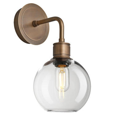 Albany Glass Globe Single Wall Light with a 7-inch clear glass globe and brass holder, shown in an angled view