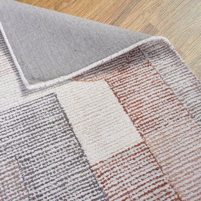 Close-up of a hand-woven rug in ivory and multi-colours, made of 90% wool and 10% cotton, featuring a textured pattern of stripes and blocks.