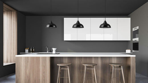 Three black pendants over a kitchen counter