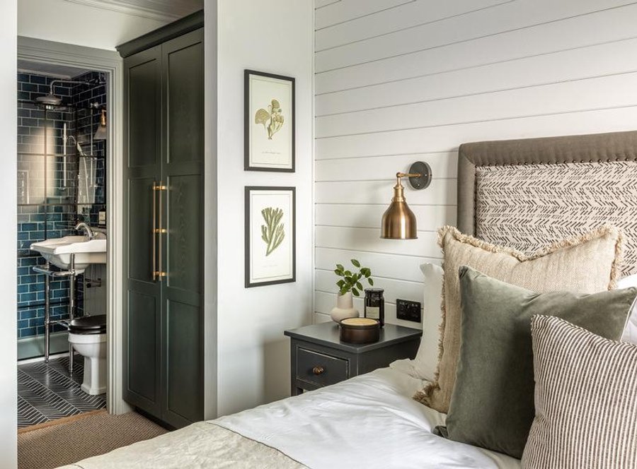 A calming bedroom decorated in whites and greens