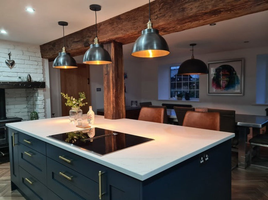 Brooklyn lights in a row of three hanging over a kitchen island  