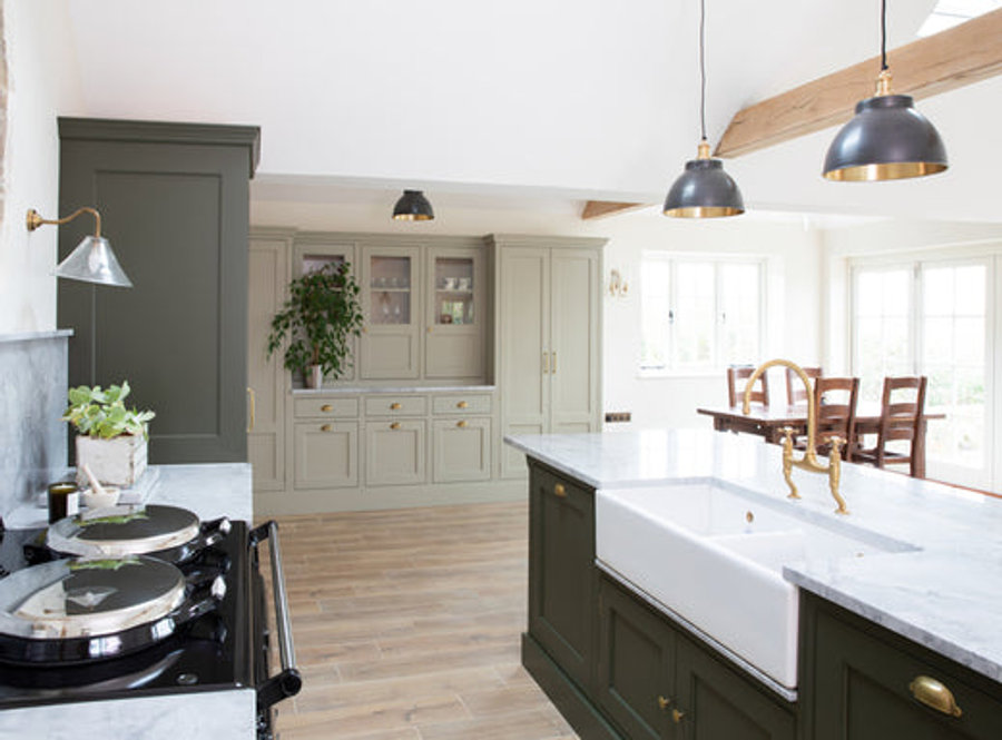 A bright open kitchen decorated with different green tones 