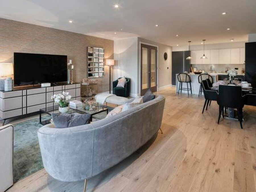 Various different lights in an open-plan living room and kitchen, including two vintage pendant lights