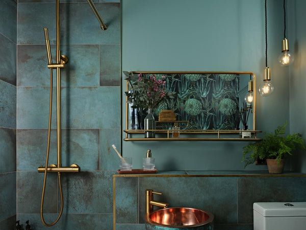 Indigo colour bathroom with brass accents and sleek edison pendants