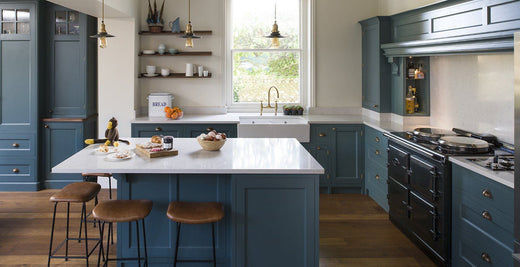 Modern style kitchen decor with teal cabinets and industrial pendants