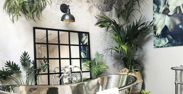 Jungle inspired bathroom decor with waterproof wall light