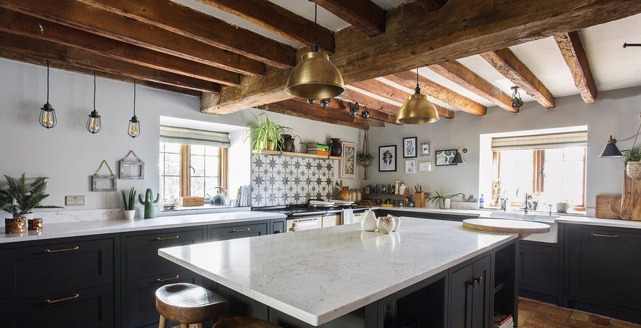 A rustic kitchen interior with industrial lighting by Industville