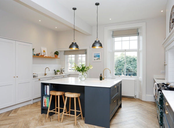 An open, green kitchen with lots of natural lights 