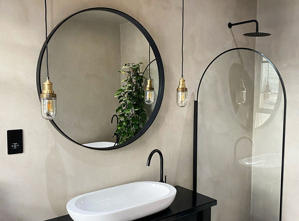 A modern minimalist bathroom interior with hanging lights by Industville