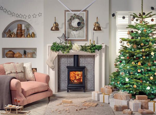 A traditional Christmas interior with pink furniture and brass lights