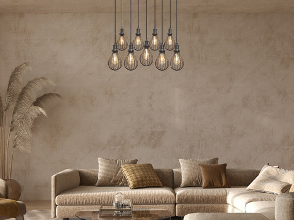 A beige living room with an industrial cluster chandelier light