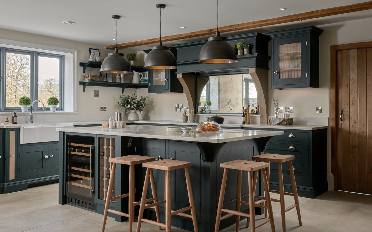 Dark kitchen with three pendants over kitchen island