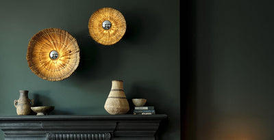 Diffuser wall lights crafted from natural grass with a woven design, creating a warm organic glow in a modern living space.