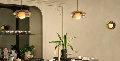 Contemporary home bar with twin mocha glass pendant lights above a black island, paired with round mocha glass wall lights for layered ambient lighting.
