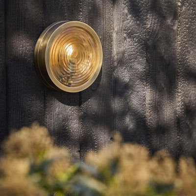 Bulkhead Outdoor & Bathroom Round Wall Light in Brass finish with Ripple Glass lit up