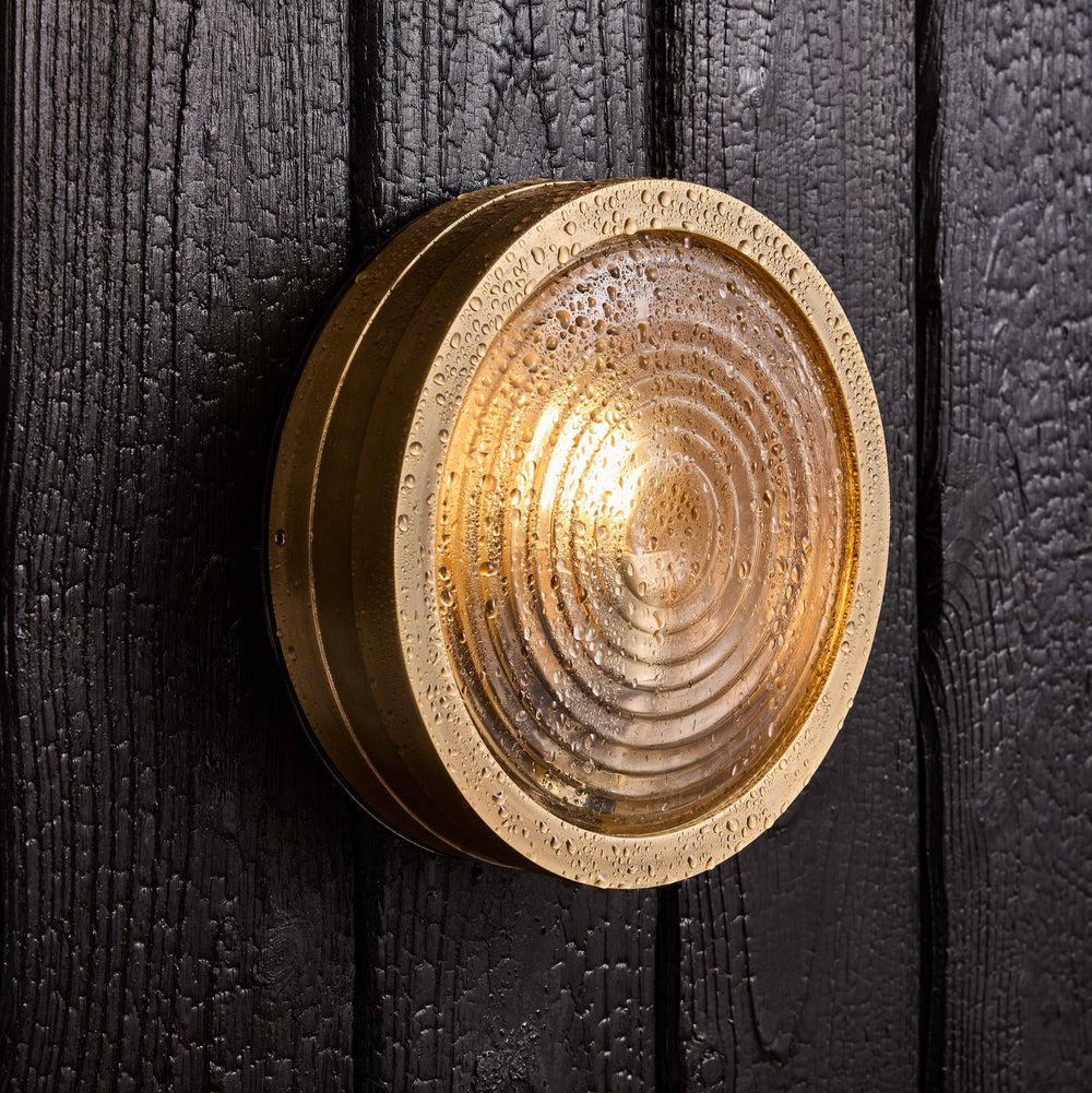 Bulkhead Outdoor & Bathroom Round Wall Light in Brass finish with Ripple Glass lit up