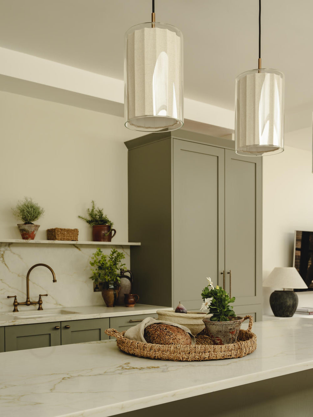 Bude Cylinder Linen Pendant Light in Clear Glass lit up in a kitchen setting