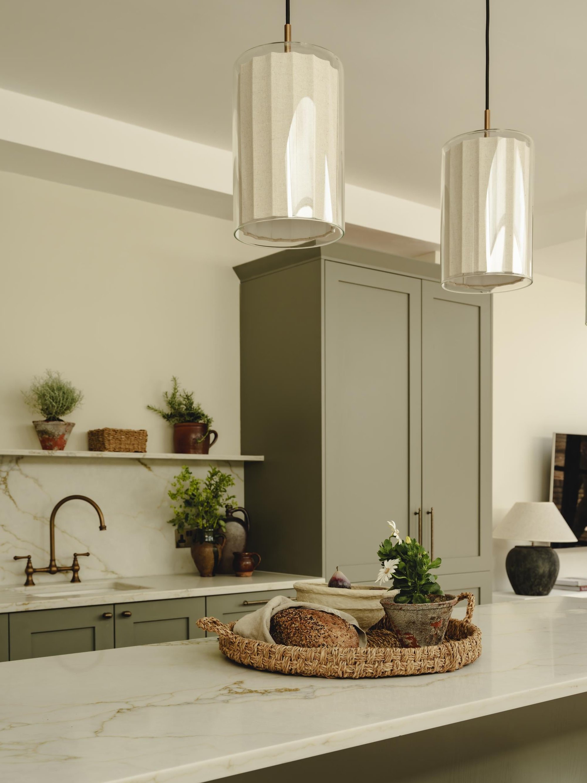 Bude Cylinder Linen Pendant Light in Clear Glass lit up in a kitchen setting