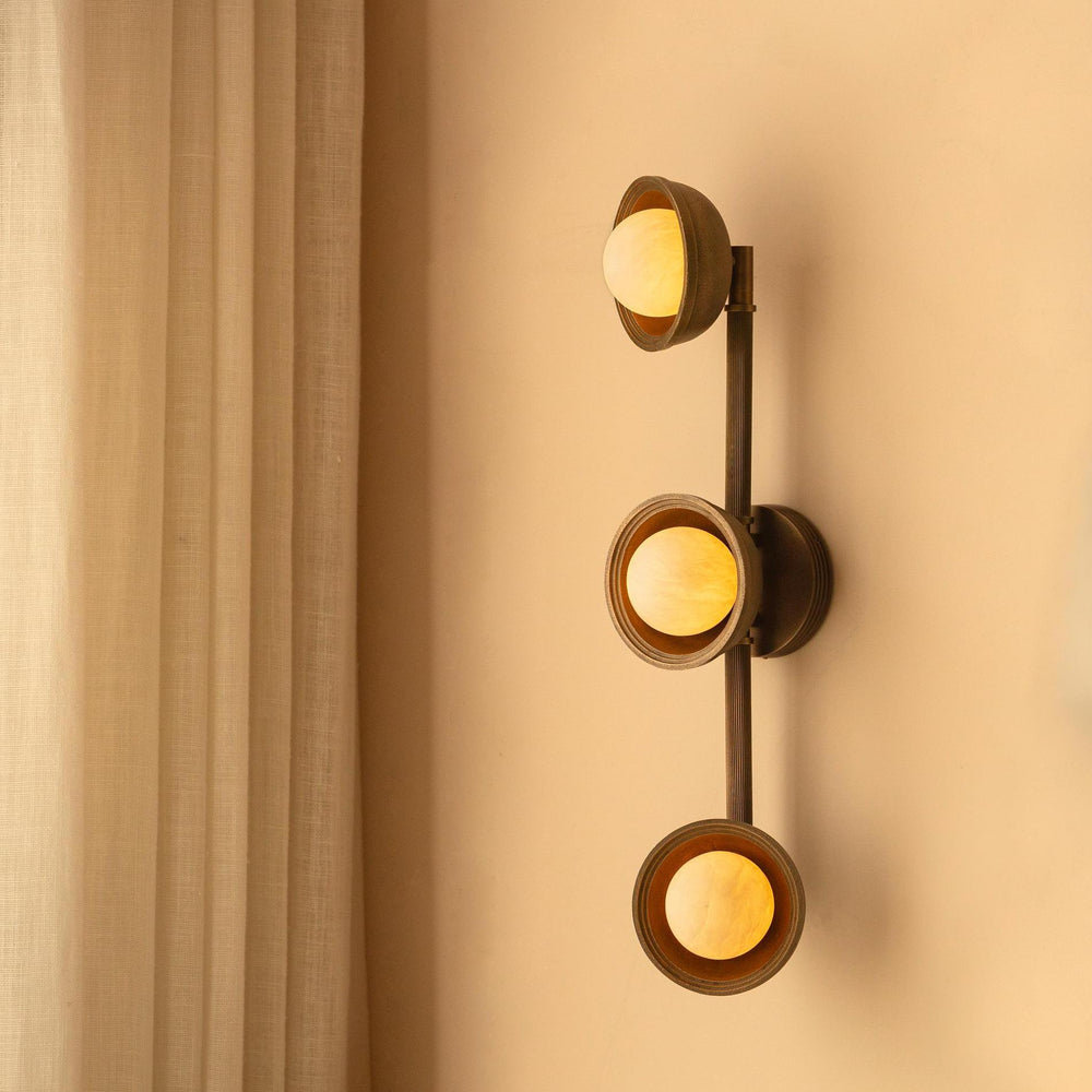 Corby Cast & Alabaster Triple Wall Light in Aged Brass lit up