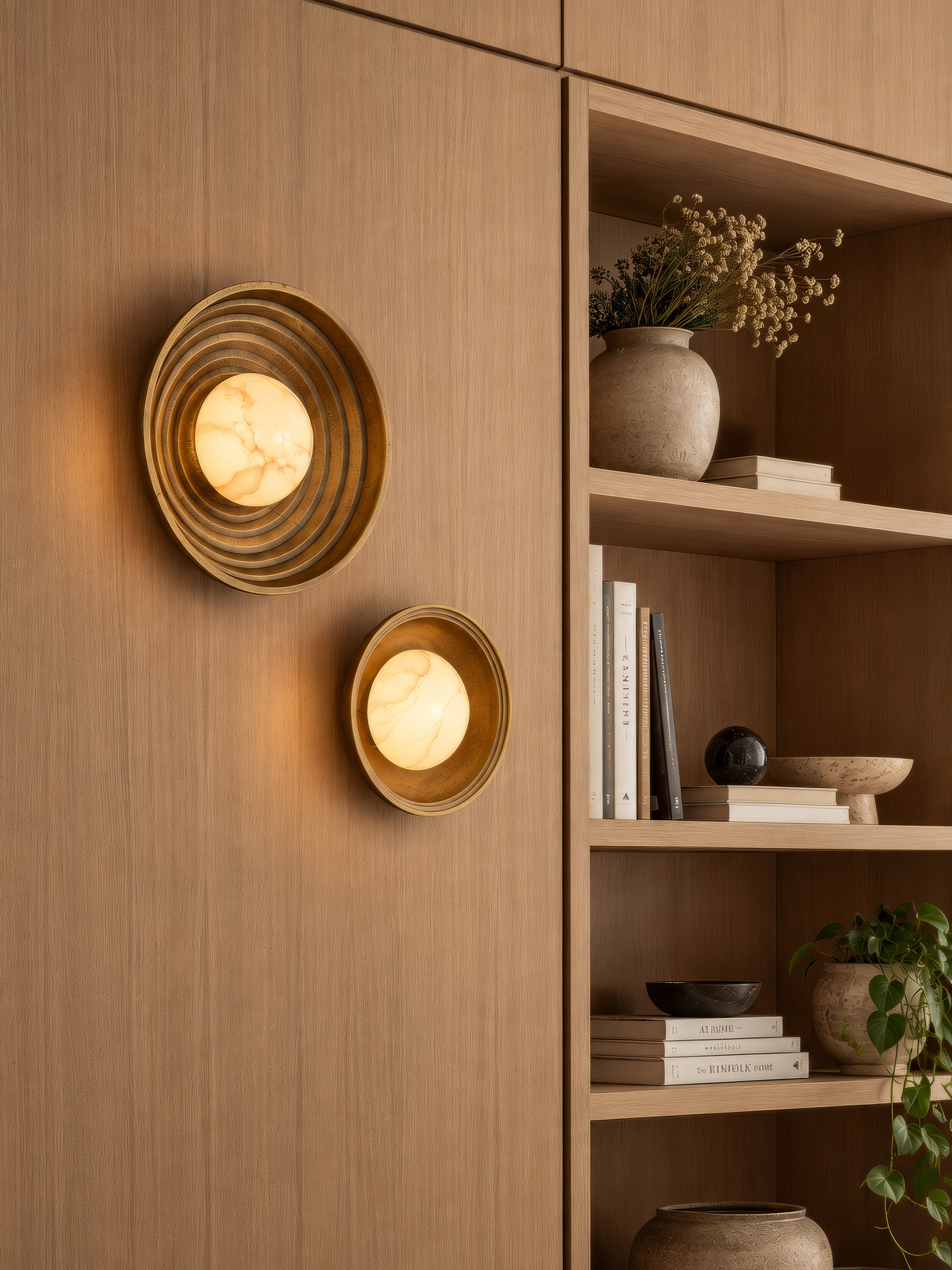 Corby Cast Stepped Diffuser Wall Light 10 Inch in Aged Brass lit up on a dark wall