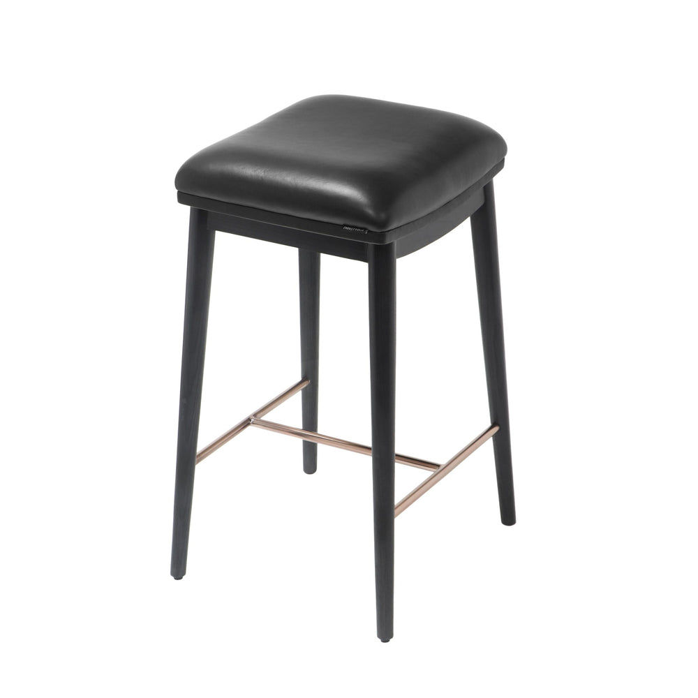 Counter height stool with black ash wood legs, black soft leather seat, and brushed metal footrest, angled view.
