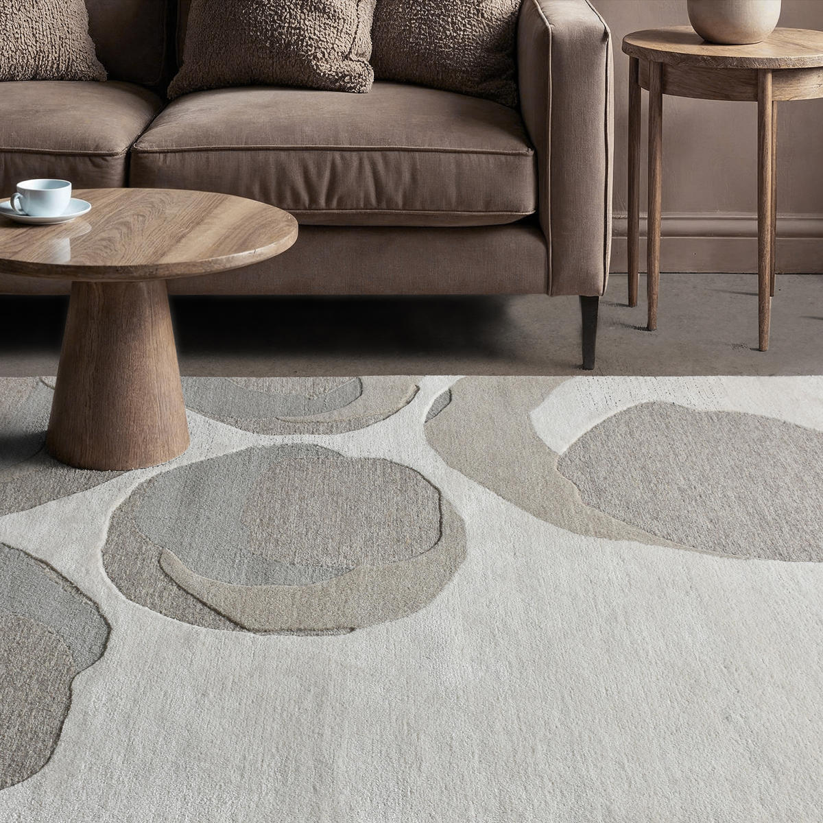 A hand-tufted wool rug with a beige and gray color scheme, showing the texture and quality of the wool.