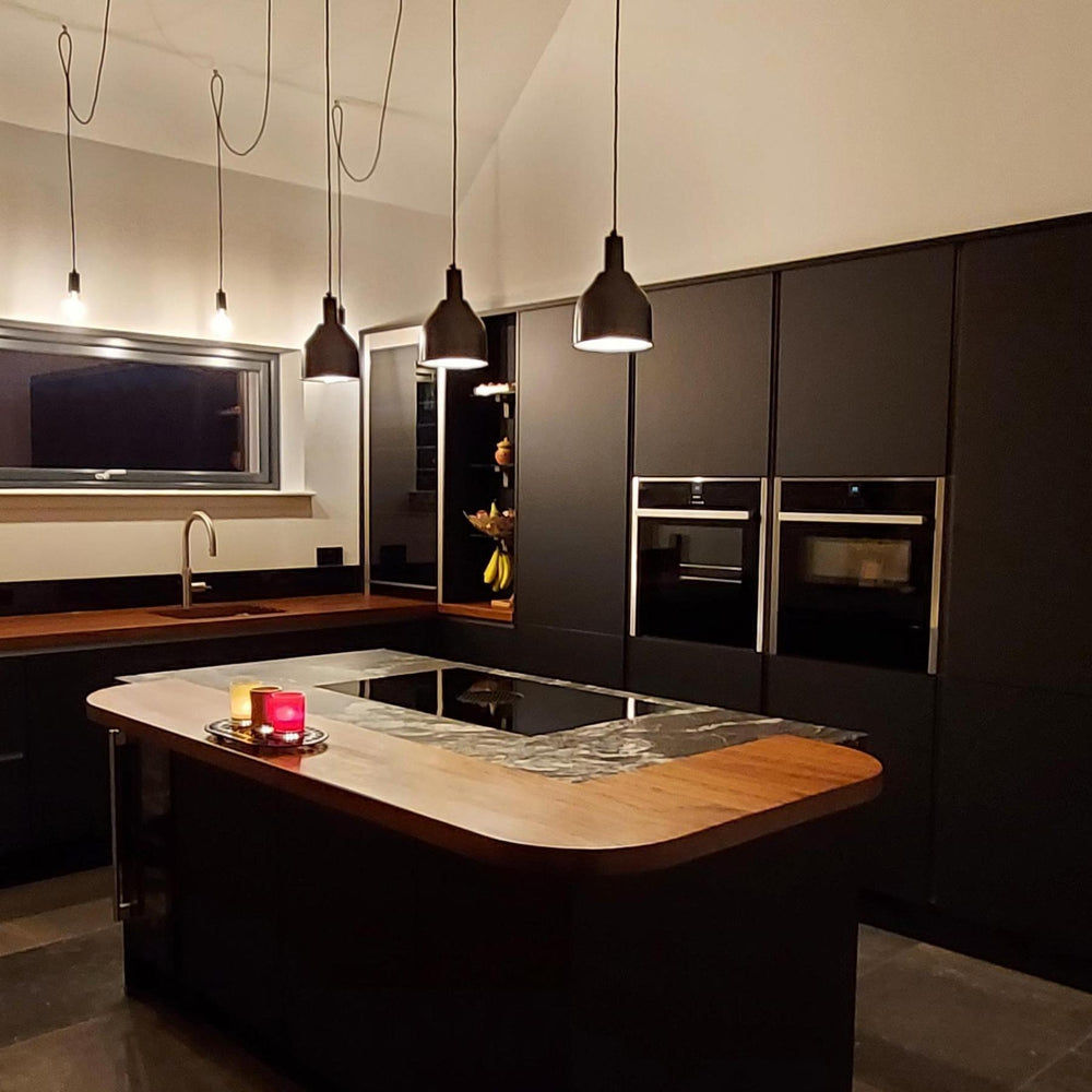 Pewter sleek cone pendant in a dark kitchen