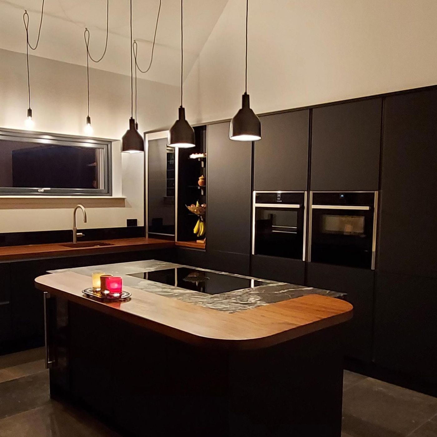 Pewter sleek cone pendant in a dark kitchen