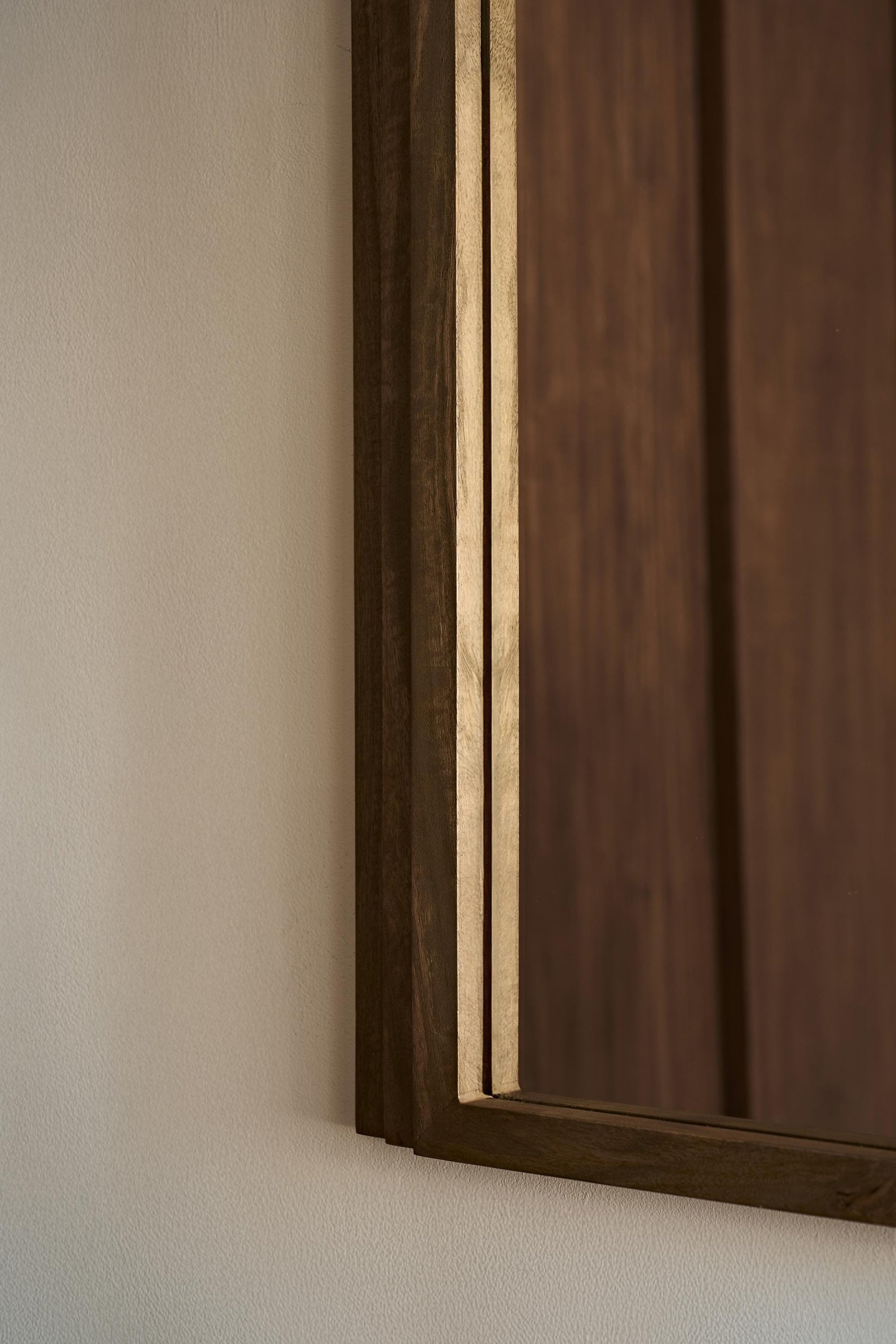 Close up of Walcott arch wall mirror with natural wood frame, 39-inch