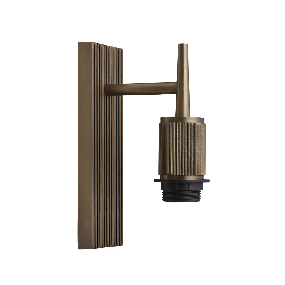 Wall light with a brass finish shown from an angled view, highlighting ribbed details without a lampshade