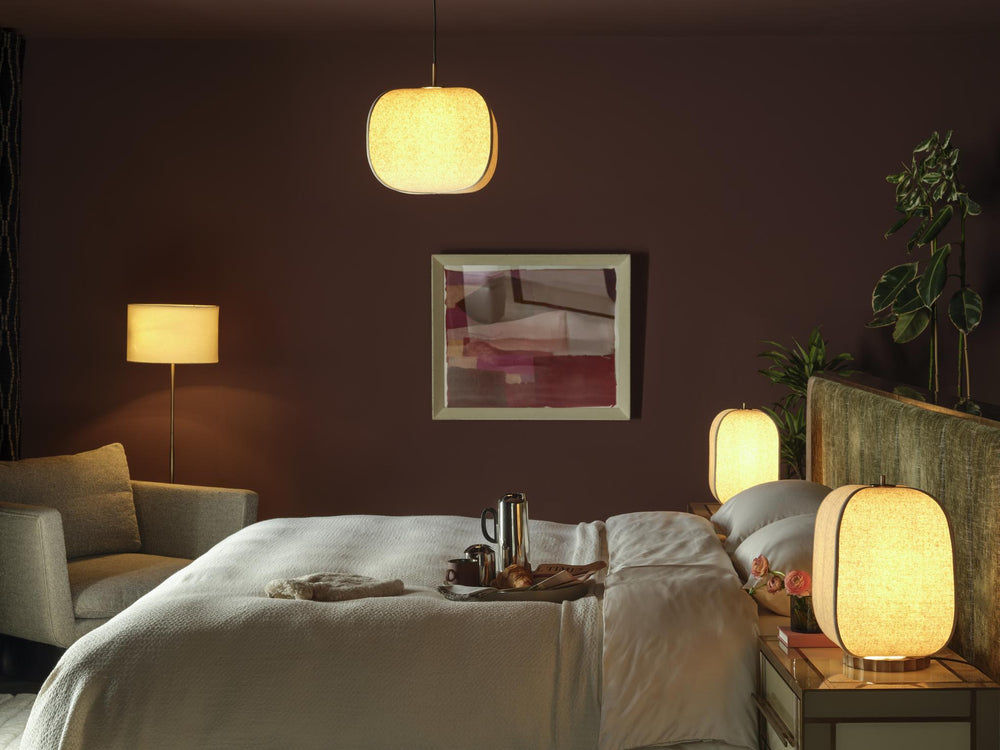 Bloxham Rectangular Table Lamp in Natural Fabric finish lit up in a bedroom setting with Bloxham pendant