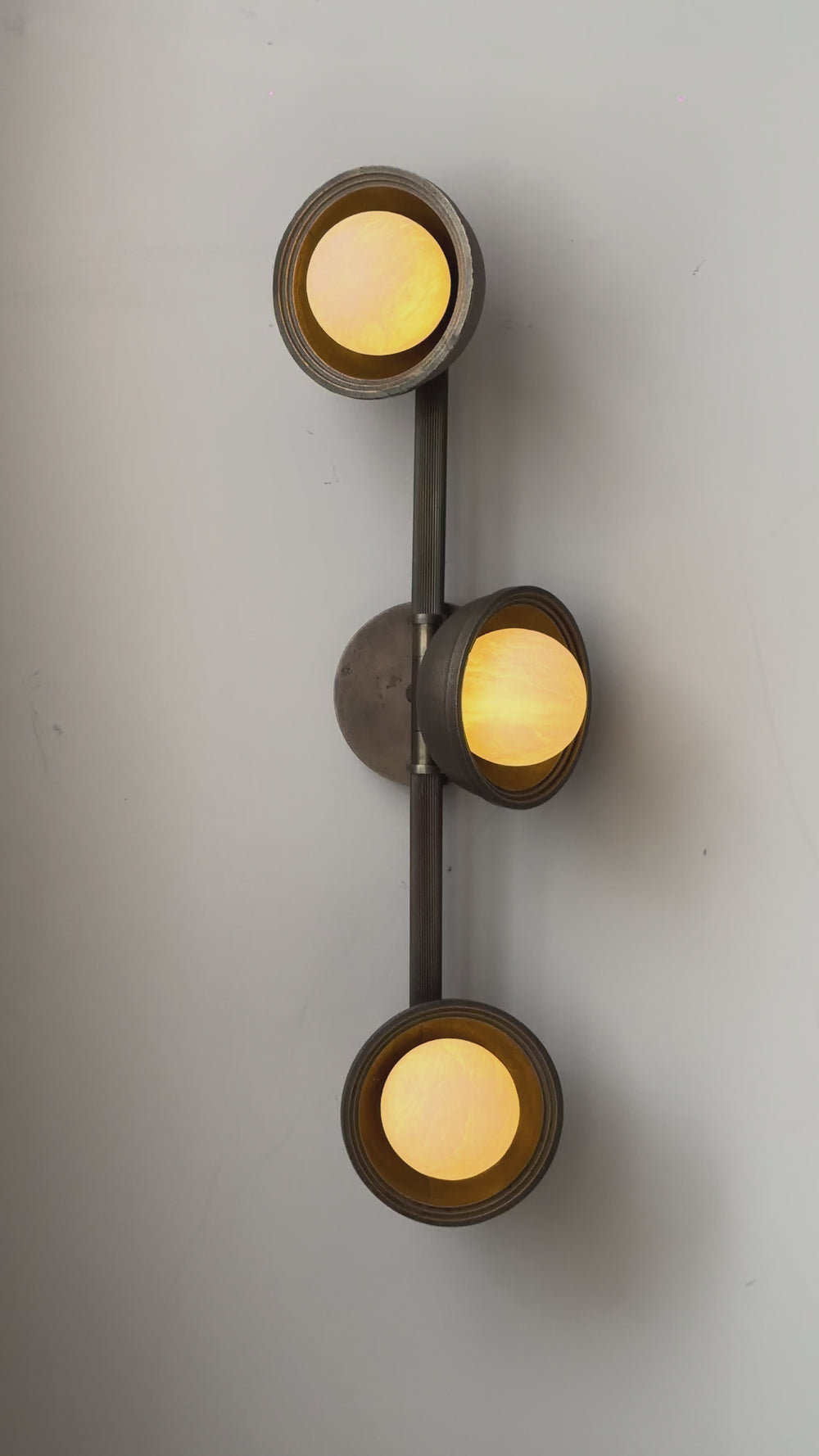 Corby Cast & Alabaster Triple Wall Light in Aged Brass lit up