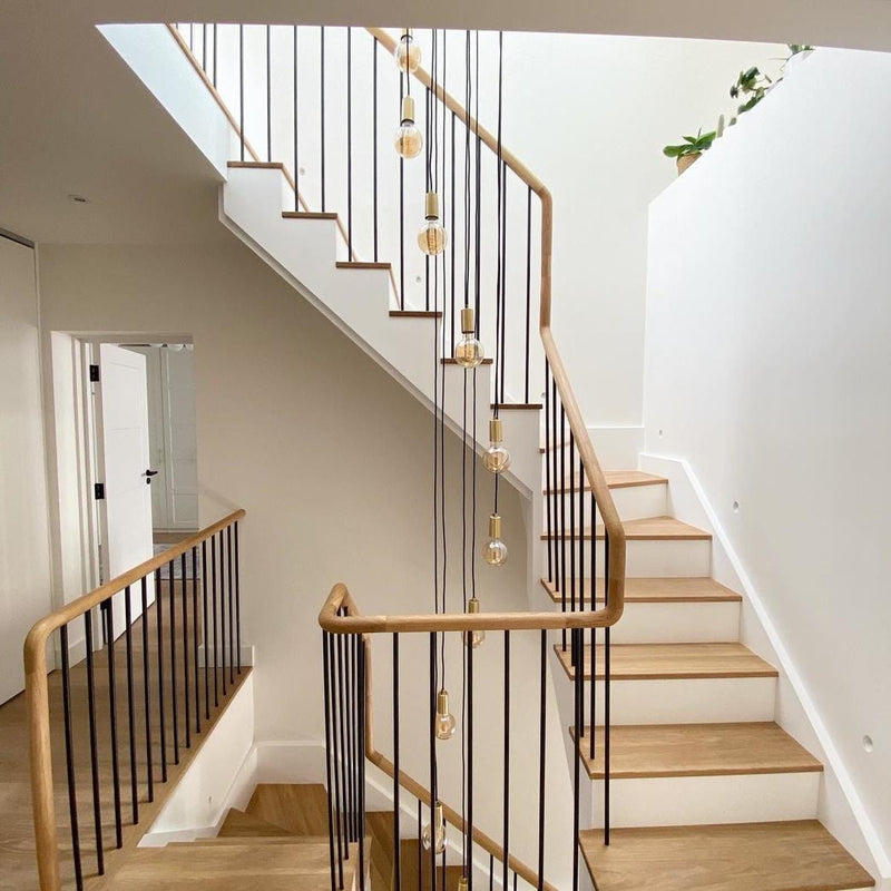 Sleek Large Edison Pendant Light in 1 Wire Brass Finish, Displayed in a Staircase